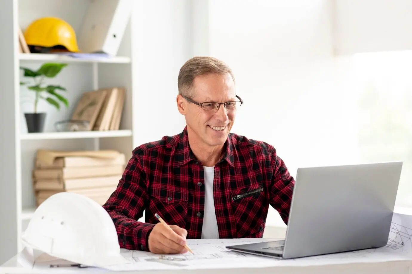 An architect using a laptop to work on his project.